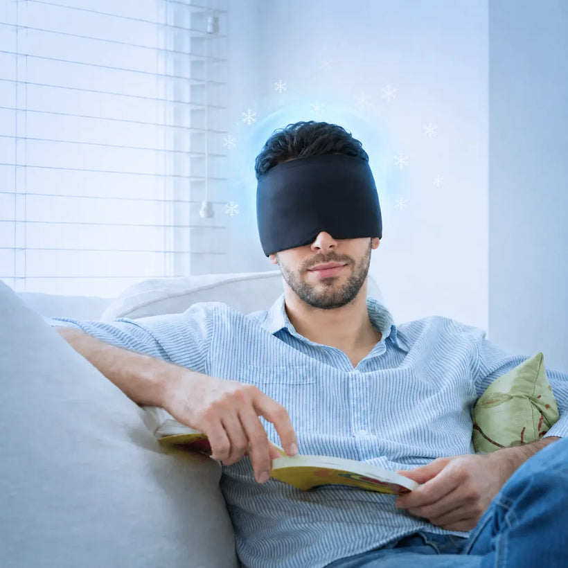 Man relaxing on a sofa wearing the black Cryovelle cap over his eyes