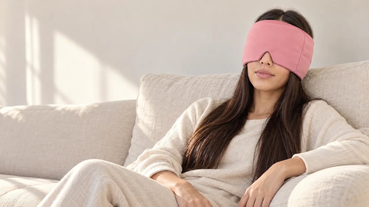 Cryovelle Therapy Mask — Blush Pink, worn by a woman relaxing on a sofa