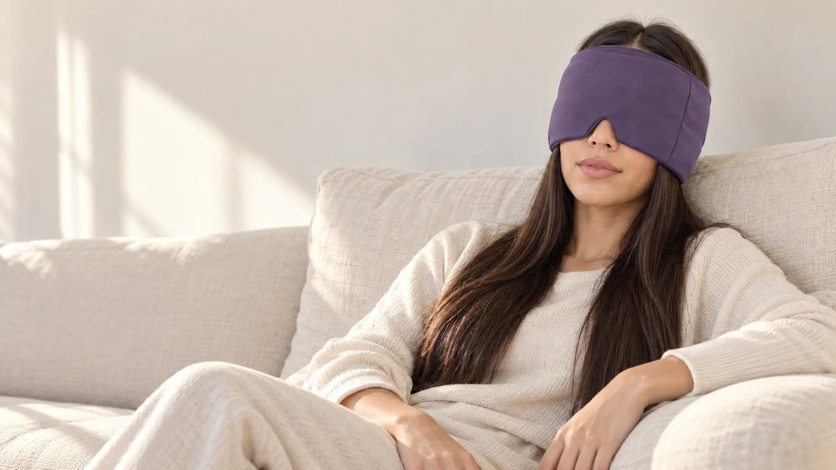 Cryovelle Therapy Mask — Deep Violet, worn by a woman relaxing on a sofa