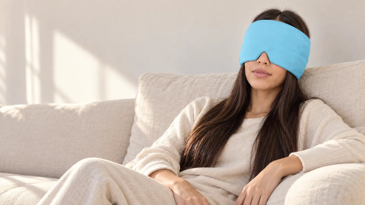 Cryovelle Therapy Mask — Glacier Blue, worn by a woman relaxing on a sofa